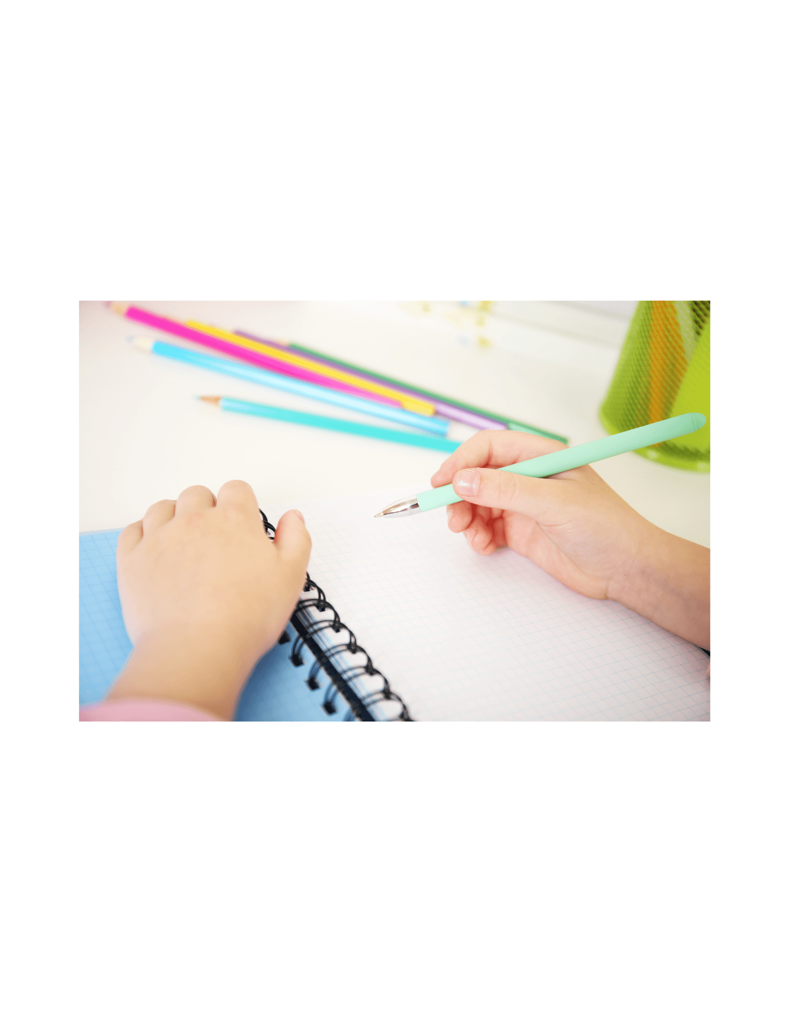 Child writing with colorful pencils during handwriting therapy